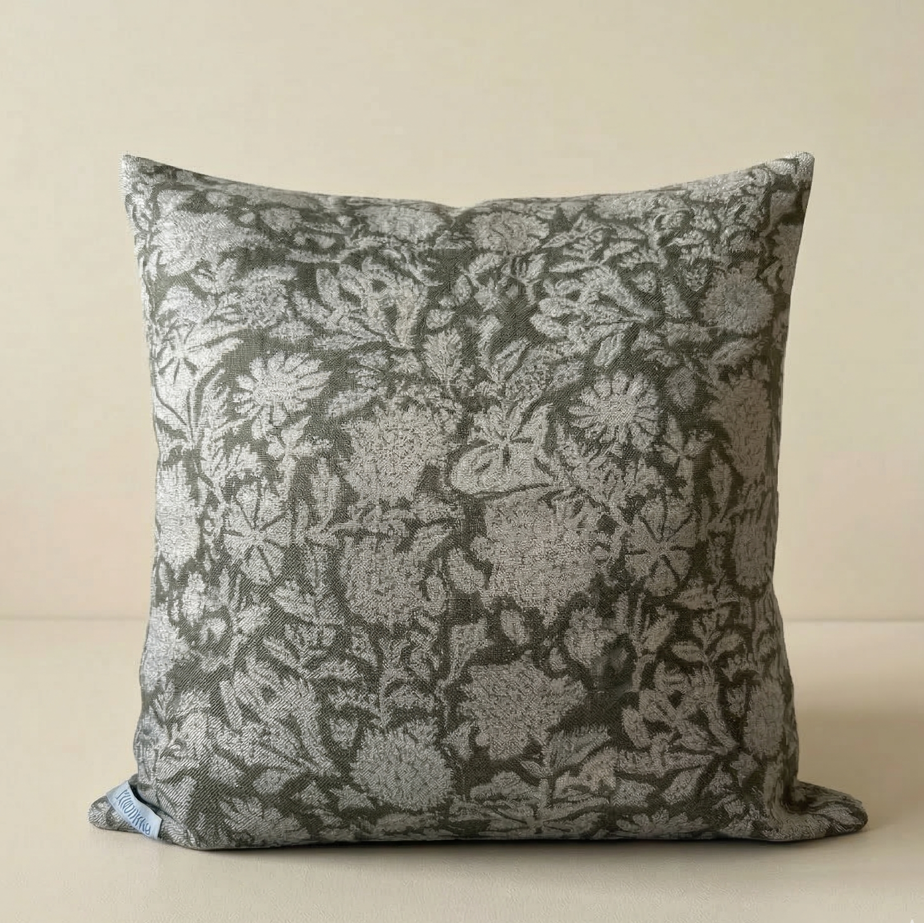 Floral patterned pillow on a beige background